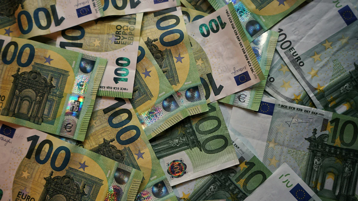 several €100 notes spread across a table