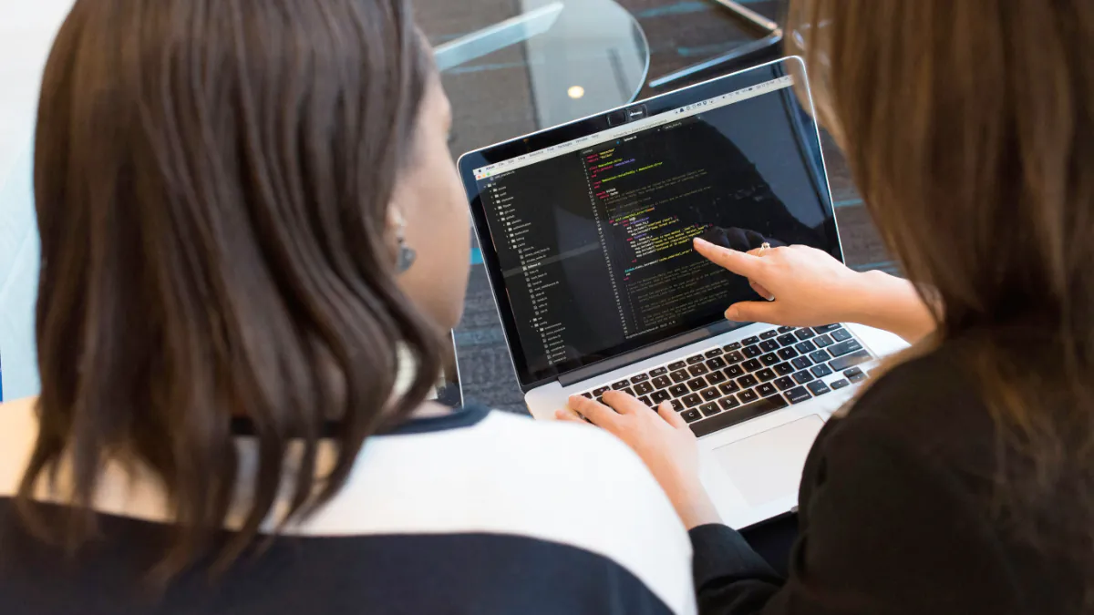 two entrepreneurs facing a computer running Ruby code