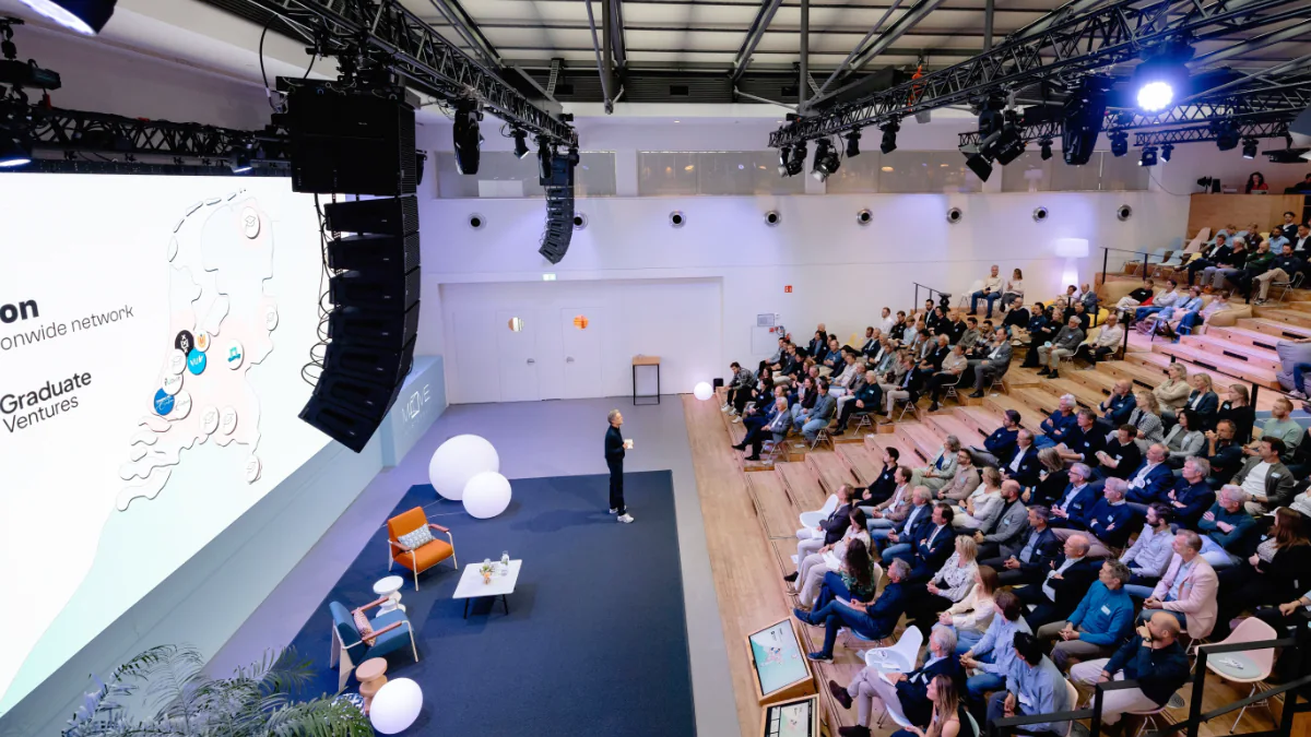 bird's eye view of an auditorium where Auke van den Hout is telling an audience about Graduate Ventures' expansion
