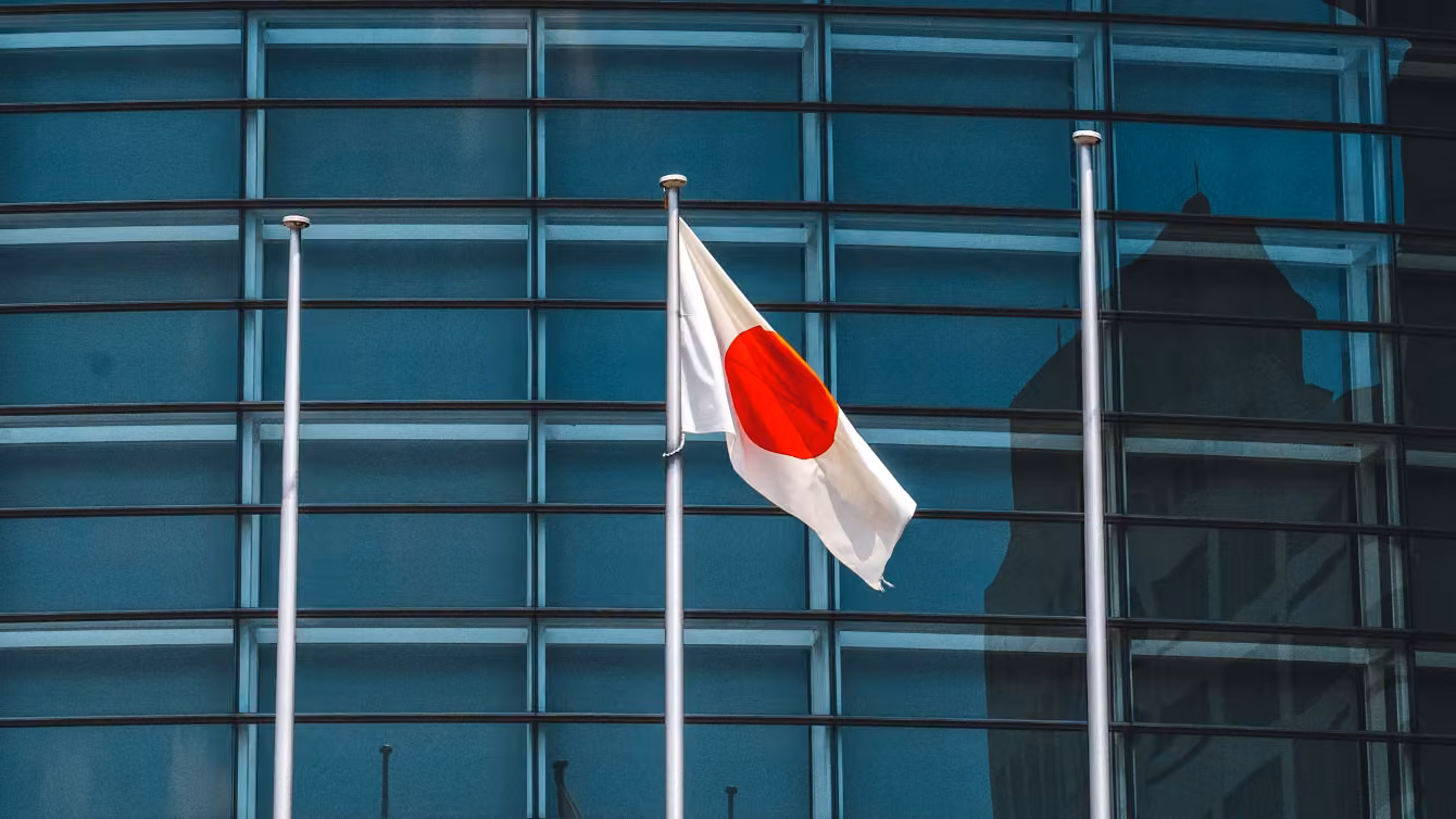 Japanese flag in front of a glass building